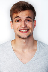 Obraz premium young handsome teenage hipster guy posing emotional, happy smiling against white background isolated, lifestyle people concept