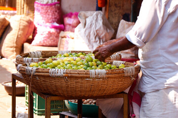 indian street market stall with basket of lemon for sell