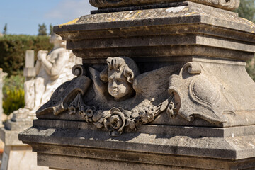 An old beautiful melancholic  and delicate angel sculpture statue at the marratxi cemetery in mallorca island balearic spain on a sunny clear day 