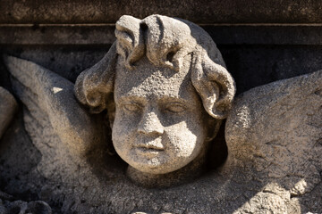 An old beautiful melancholic  and delicate angel sculpture statue at the marratxi cemetery in mallorca island balearic spain on a sunny clear day 