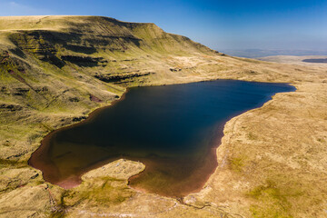 Fototapeta na wymiar Aerial view of a beautiful glacially formed lake in a rural setting (Llyn y Fan Fawr)