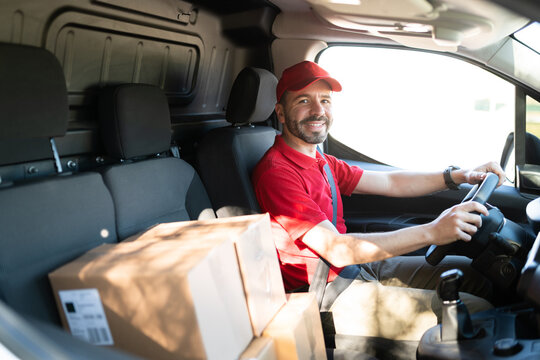 Portrait of a happy male driver making deliveries in a van