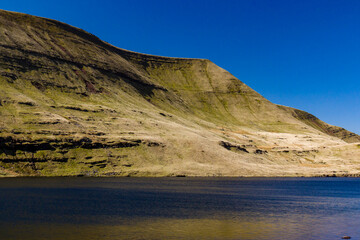 Aerial view of a beautiful glacially formed lake in a rural setting (Llyn y Fan Fawr)