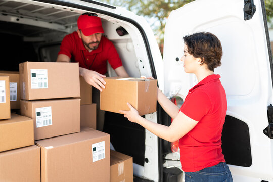 Delivery persons unloading packages from a van