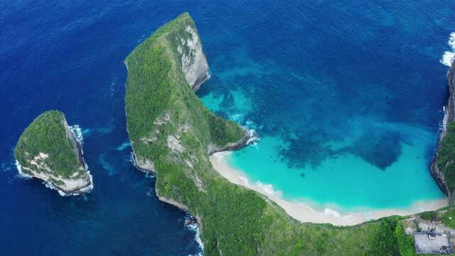Aerial drone landscape view of the famous white sand beach of Kelingking located on the southern coast of Nusa Penida island in Bali in Indonesia.