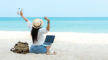 Lifestyle freelance woman listen music after using laptop working and relax on the beach.  Asian people success and together your work pastime and meeting conference on internet in summer holiday