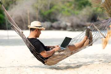 Lifestyle freelance man relax and sleeping on the hammock after using laptop working and relax on...