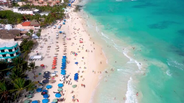Drone shot of Playa Del Carmen coastline and resorts with people on the beach