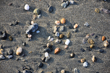 colorful small pebbles on the sand on the beach