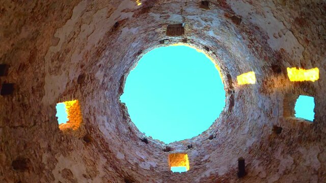 Old mill, inside view, the camera looks up to the roof where the sky is visible, the concept of old buildings