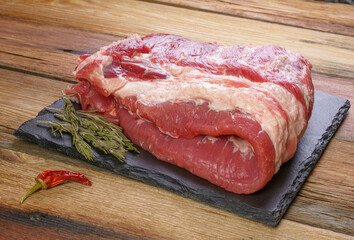 Raw pork ribs. Top the meat ingredient on a slate serving board. close-up.Selective Focus