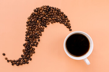 Beige flat lay, cup of coffee, roasted coffee beans steam shape from hot coffee