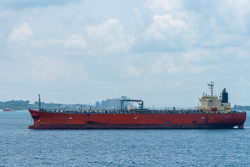Oil tanker ship anchored in front of the Singapore downtown. 