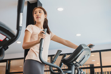 Workout woman, girl, exercise on elliptical cross trainer in fit sportswear, practice working out training for health. Sport strong person in gym fitness for healthy lifestyle, recreation concept.