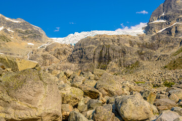 Scenery of high mountain peak over blue sky.