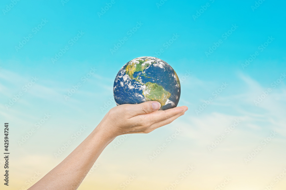 Canvas Prints globe in hands over blue sky background. save of earth. elements of this image furnished by nasa