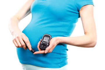 Pregnant woman holding glucometer checking sugar level, diabetes during pregnancy