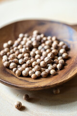 coriander seeds. pepper in a wooden bowl.