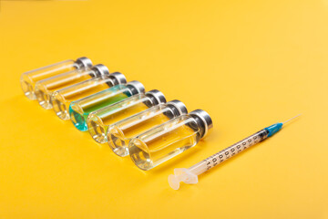 Glass vaccine ampoules, bottles, syringes, medicines, top view