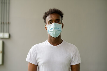 African man wearing face mask and looking at camera