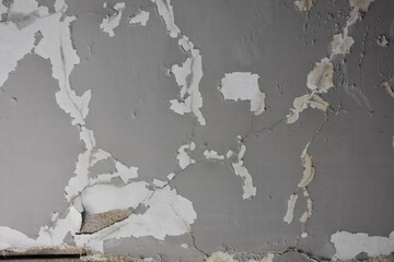 wall of an old house with torn whitewash