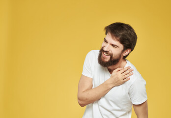 Yellow background model white t-shirt close-up brunette mustache beard