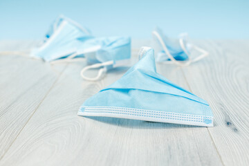 Used medical protective masks on a floor.