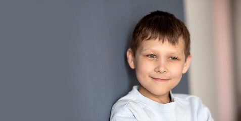 portrait of a boy 8-10 on a blue isolated background, space for text, selective focus