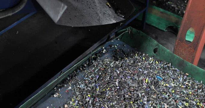 Crushed batteries fall into the tray in a heap. Sorting, recycling and disposal. Environmental protection concept.