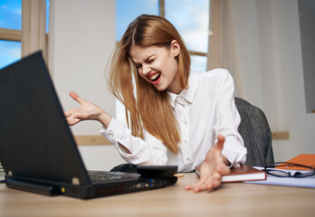 business woman working desk laptop in office emotions dissatisfaction communication