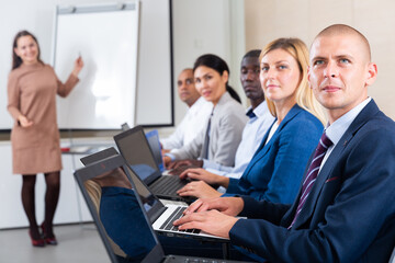 Fototapeta premium conference of international financial managers with laptop in white room