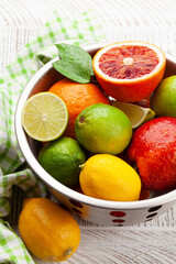 Various fresh citrus fruits in colander