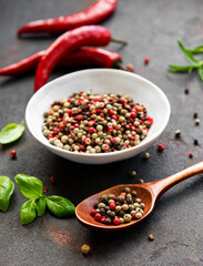 Red hot chili pepper corns and pods on dark  background, top view