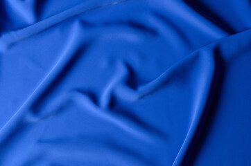 The background is made of a delicate blue chiffon fabric with folds in the form of waves.