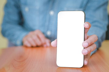 The man is handing out a white mobile phone screen to the front. Text can be placed in copy spaces. Concept of technology, Social and communication