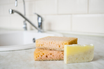 Zero waste products for personal care. Eco friendly natural bamboo sponge under the kitchen. Washing dishes. Hand washing