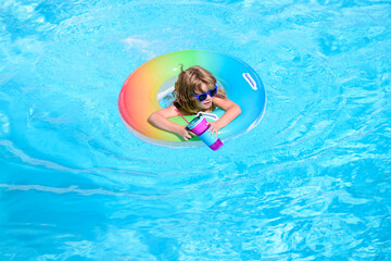 Kid with cocktail on watter pool in the summer.