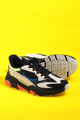 Sports shoes. The sneakers are stylish in isolation on a yellow background. High quality photo