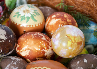 Easter eggs, European Easter with traditional decoration eggs, easter eggs decorated with natural fresh leaves and boiled in onions peels and blueberry berries