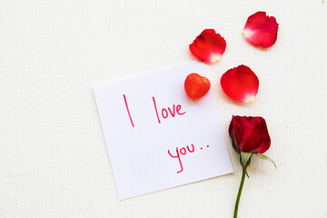 i love you message card handwriting with red rose flowers arrangement flat lay postcard style on background white