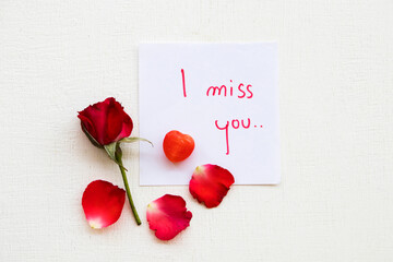 i miss you message card handwriting with red rose flowers arrangement flat lay postcard style on...