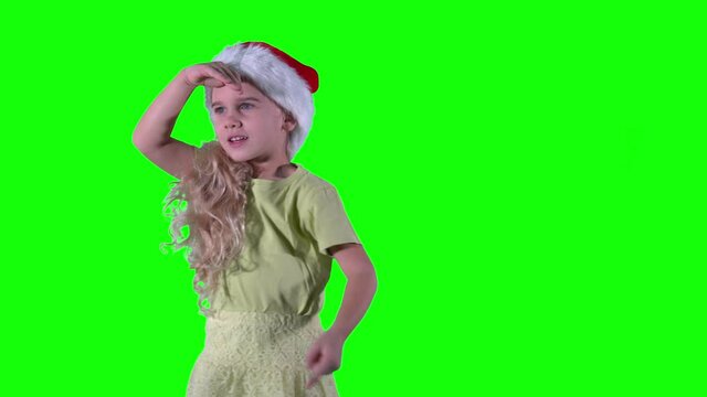 Adorable child looking around. Curly hair girl showing with finger. Chroma key