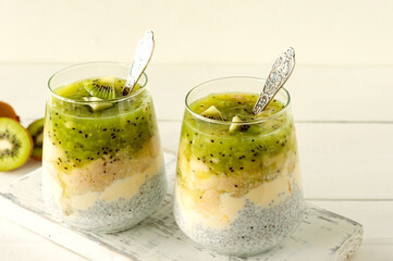 Chia seed pudding with kiwi, banana and mango. Health detox breakfast in glasses on white background