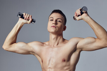 Fototapeta na wymiar sporty man with dumbbells in hands exercise muscles strength