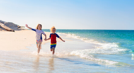 Fototapeta na wymiar Kids playing on beach. Children play at sea.