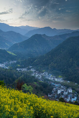 Obraz premium sunrise in a foggy morning at a small village in Shexian, Anhui, China.