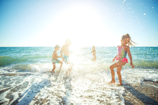 Children have fun on the sandy beach in summer. High quality photo.
