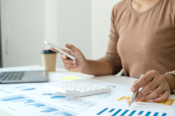 work from home, The hand of a woman who works in finance sits at his desk at home and calculates...