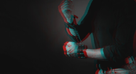 A man hands wearing a pair of black furry leather sex toy handcuffs for sex. Black and white with...
