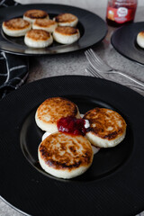 cheesecakes with strawberry jam on a plate